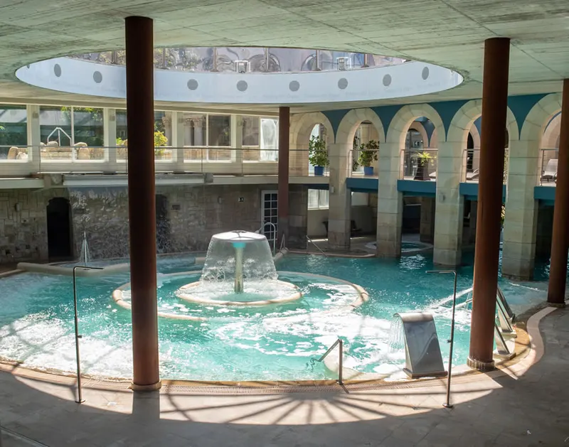 Round pool with fountain under a glass dome