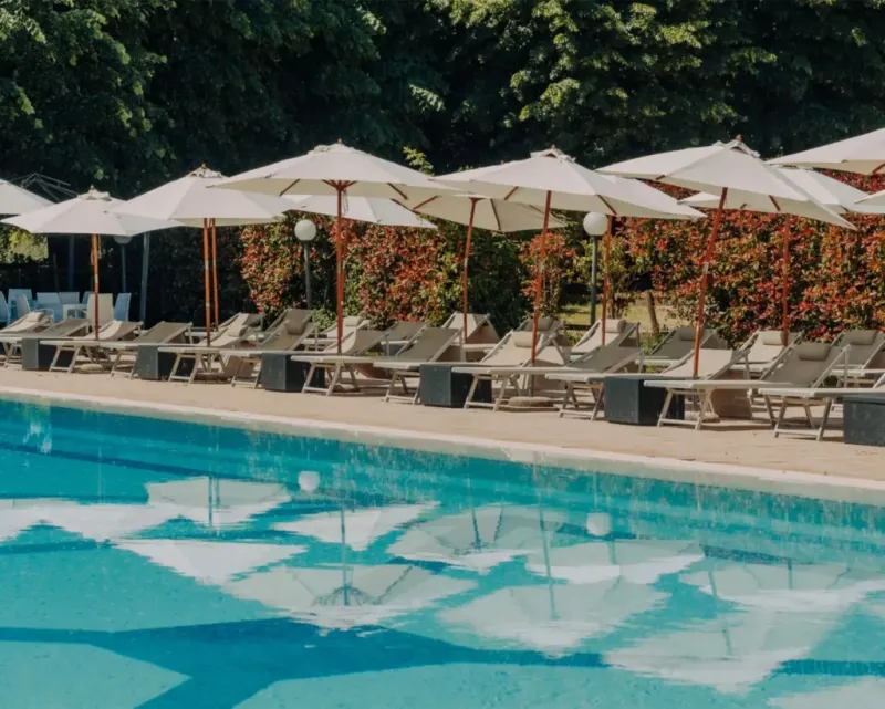Pool with sunbeds in the park