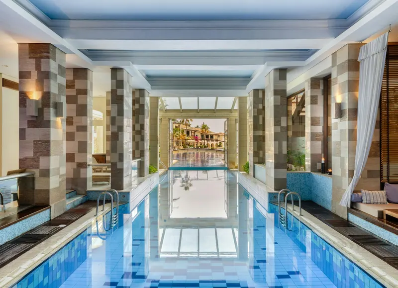 Indoor spa pool under a columned hall