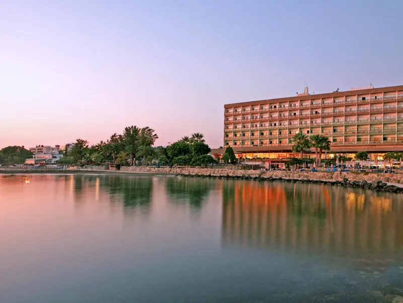 The hotel at dusk across the calm water