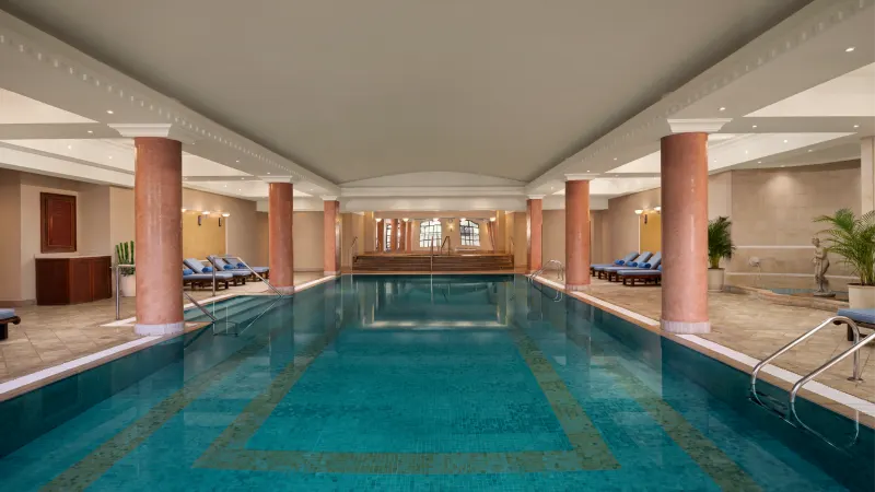 Indoor spa pool with columns and loungers