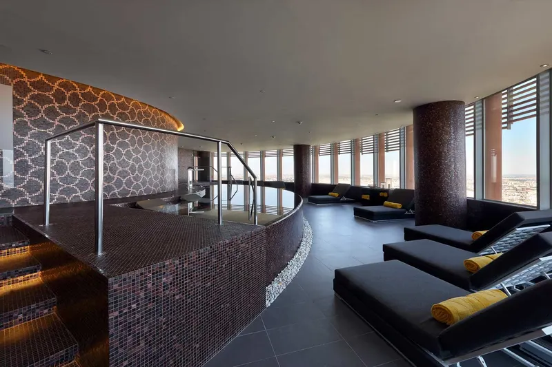 Mosaic-tiled spa pool with loungers