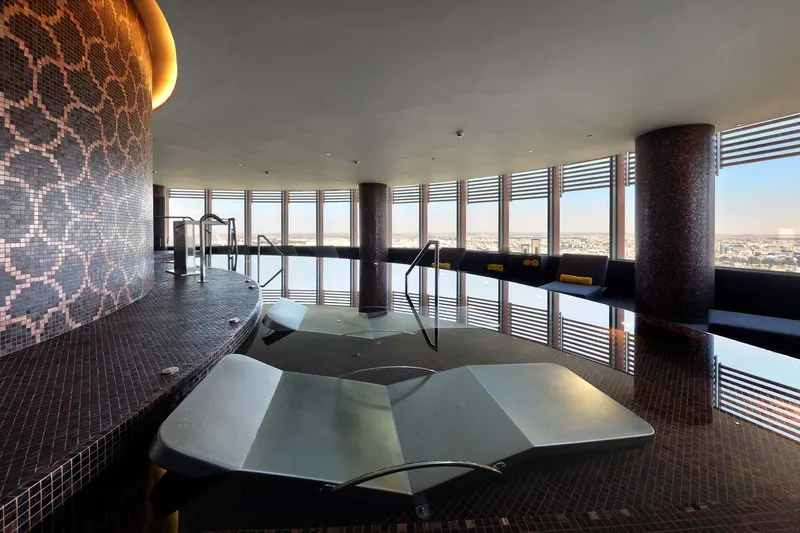 Heated loungers in the spa with city views