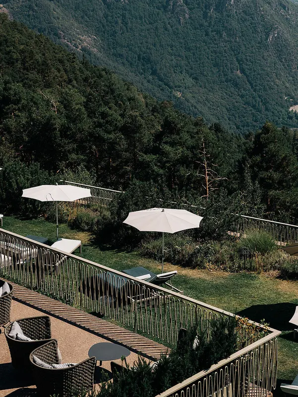 Garden terrace with parasols and mountain view
