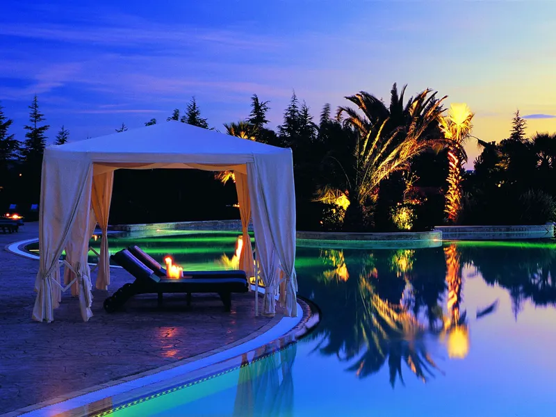 Poolside cabana lit up in the evening