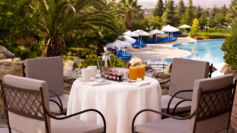 Breakfast table set beside the outdoor pool