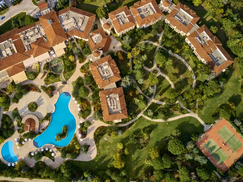 Aerial view of the hotel grounds with the pool and tennis court