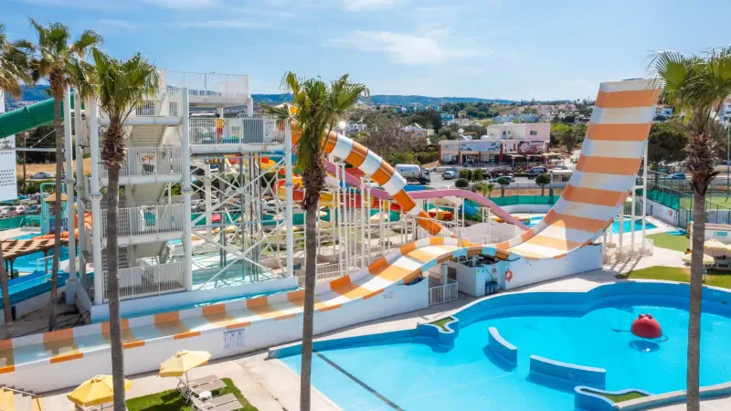Kids pool area with slides and palm trees