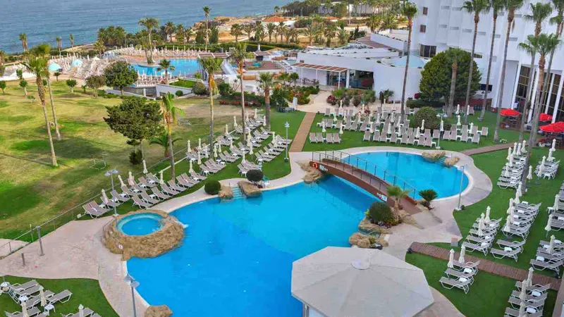 Lagoon pool and garden with sunbeds near the sea