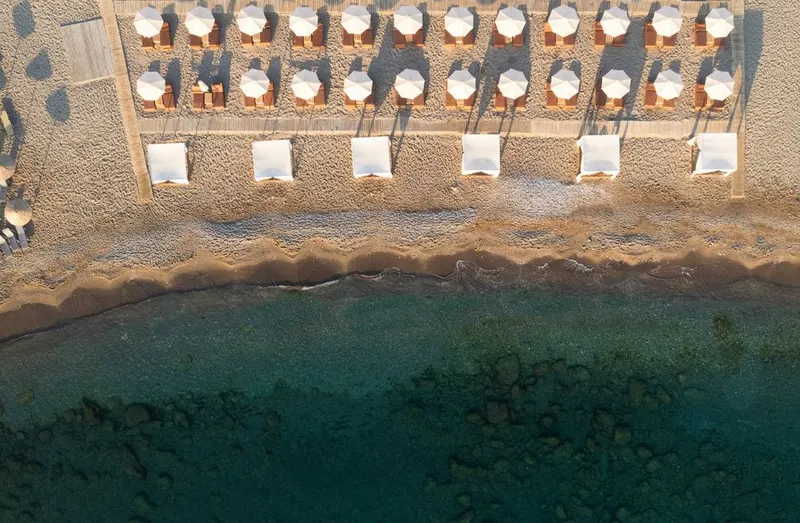 Rows of beach sunbeds from above